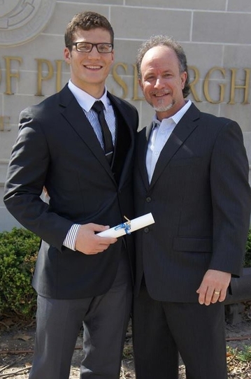 standing with my step dad at graduation